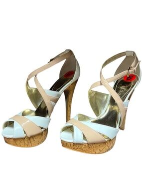 Strappy white and nude heels with cork platform.